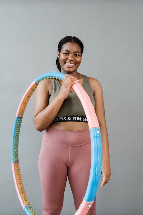 Woman in Gray Sports Bra and Pink Workout Pants Holding A Hula