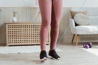 Woman in Pink Leggings and Black Nike Sneakers