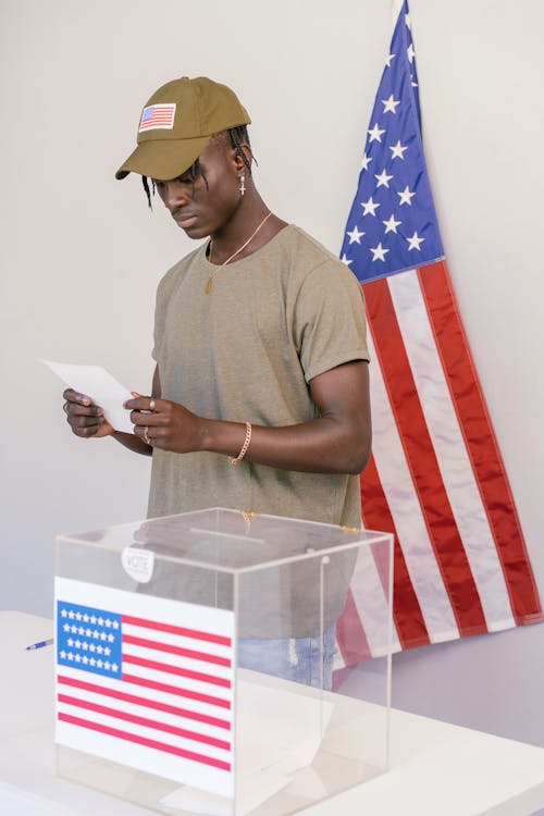 Man Looking at White Paper