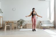 Woman in Black Tank Top and Pink Shorts Standing on White Floor