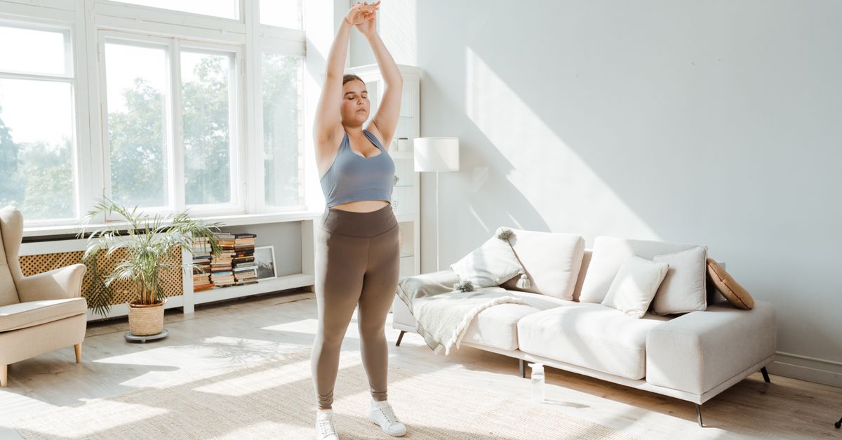 person doing gentle morning stretches in living room