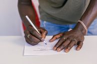 Close Up Photo of Person Selecting Votes