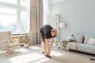 Man in Gray T-shirt and Black Shorts Kneeling on Floor