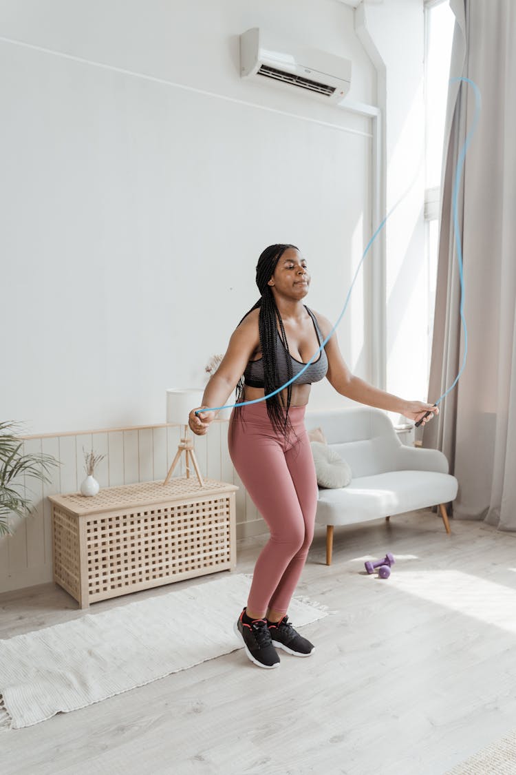 A Woman Using A Skip Rope At Home