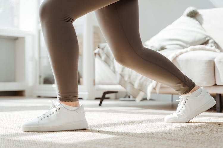 Woman In White Sneakers Doing Squats