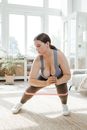 Woman in Blue Sports Bra and Gray Leggings Doing Exercises with Pink Rubber Strength Band