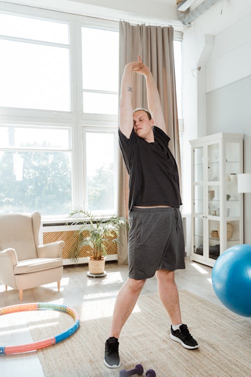A Man in Black Shirt Working Out in the Room