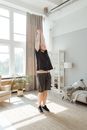 Woman in Black Tank Top and Black Shorts Standing on White Floor Tiles