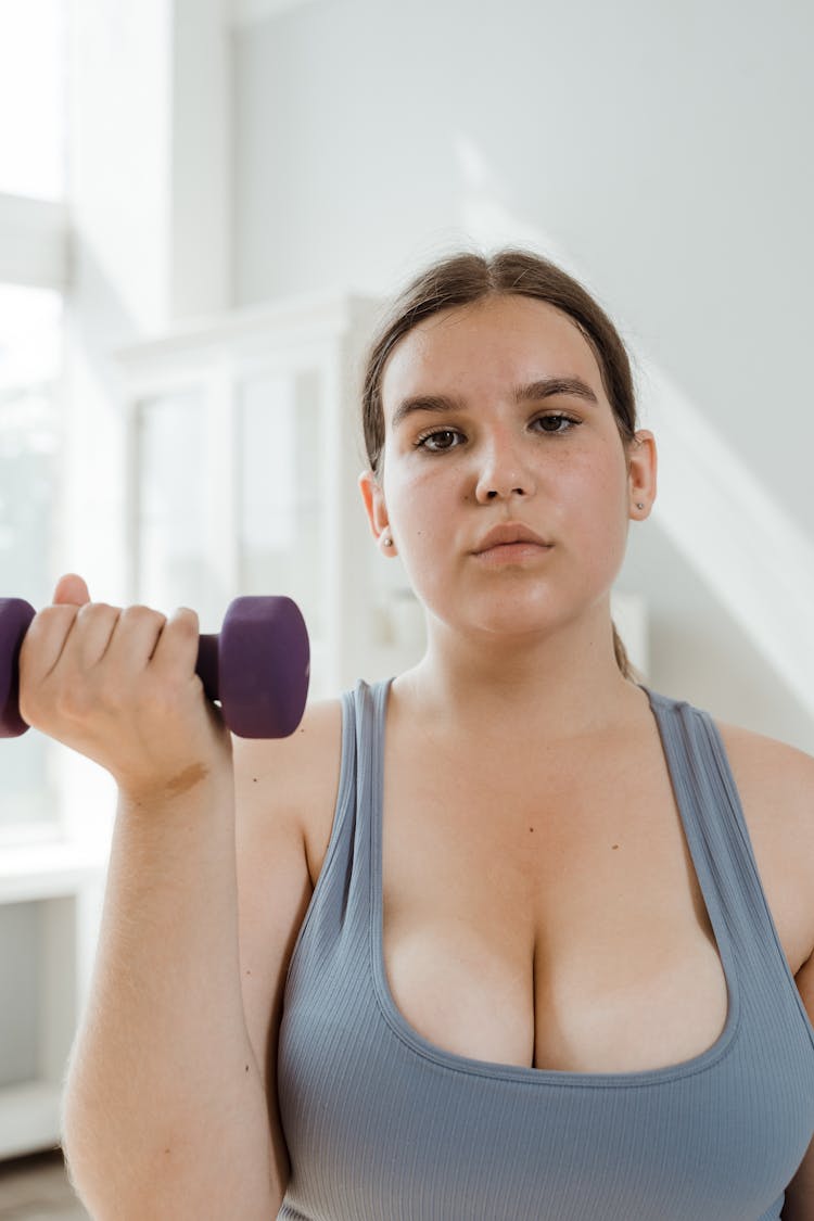 A Woman Lifting A Dumbbell