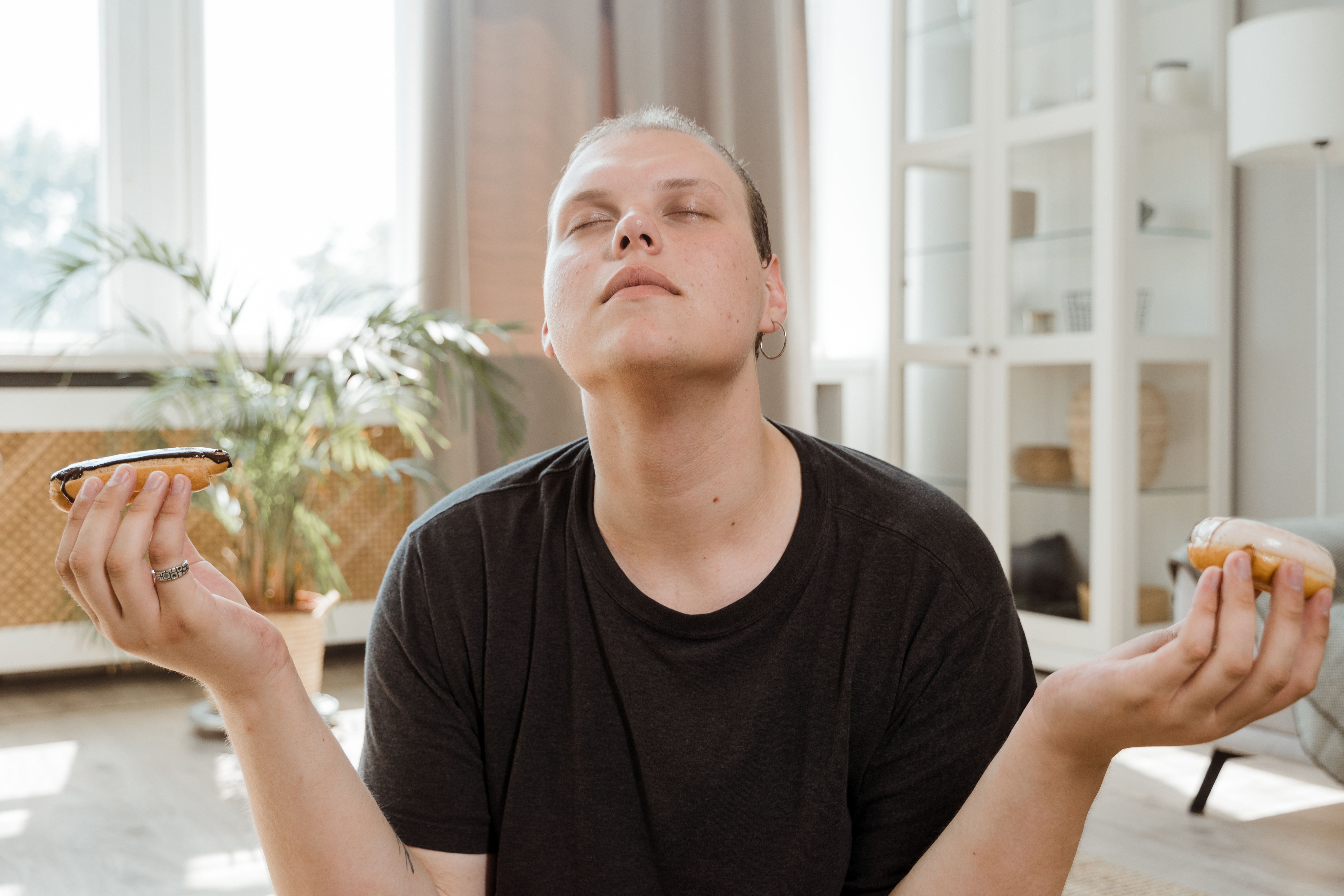A split-screen image showing a tired person reaching for a donut on one side, and a well-rested person choosing a smoothie on the other