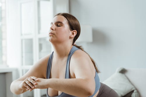 Woman Exercising with Her Eyes Closed