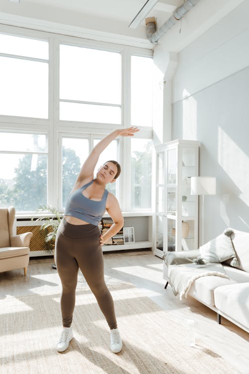 Free 
A Woman Stretching Indoors Stock Photo