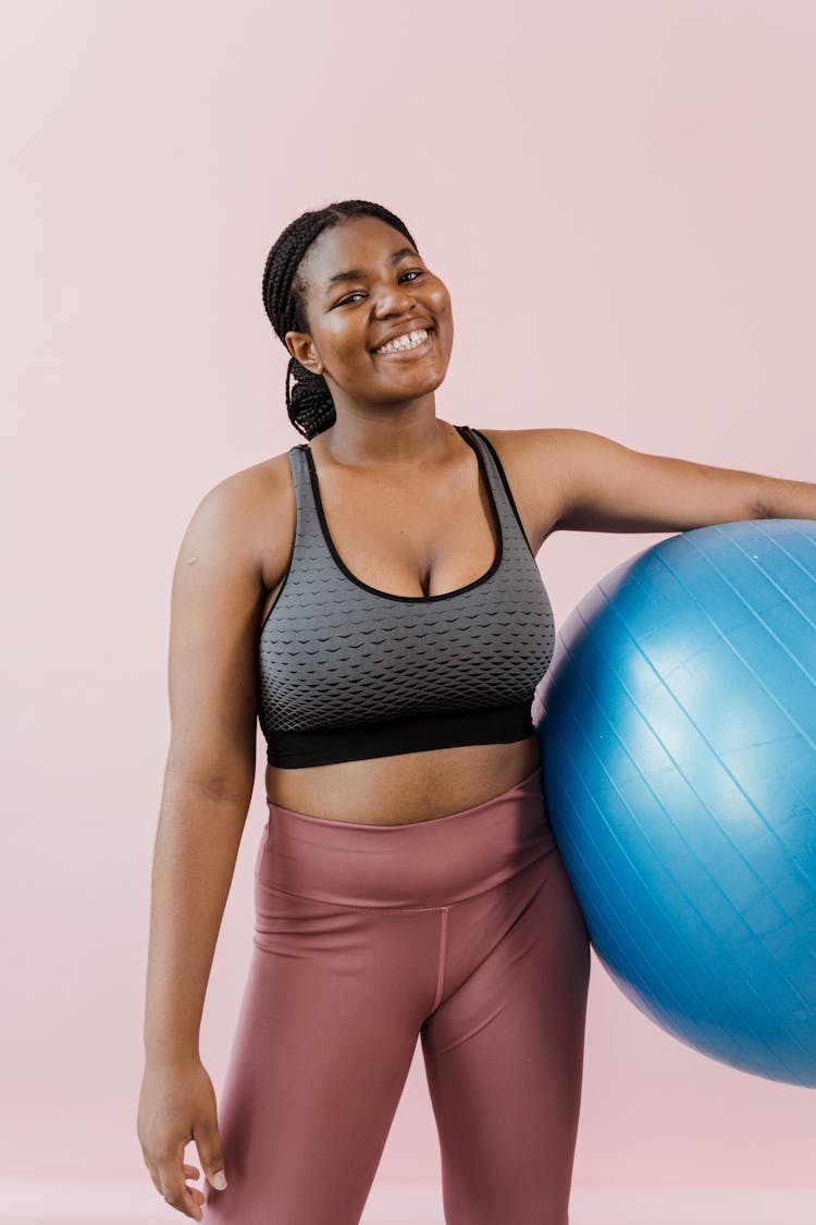 A Woman Holding A Yoga Ball