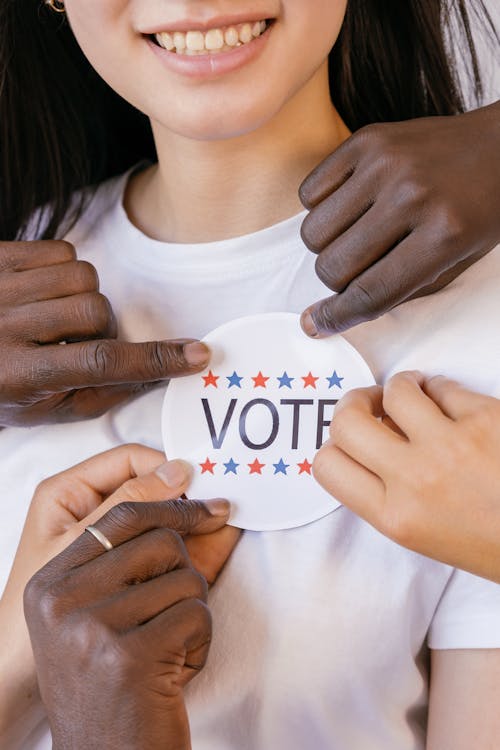 Free Close Up Photo of Voter's Badge Held by Hands Stock Photo