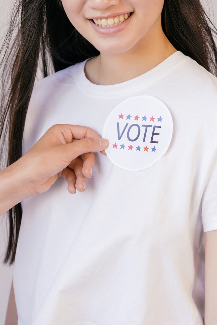 Person Holding Vote Badge