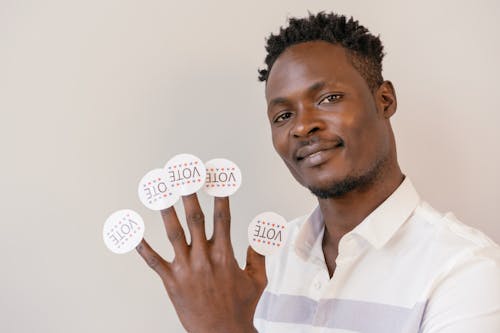 Voter Stickers on Man's Fingers