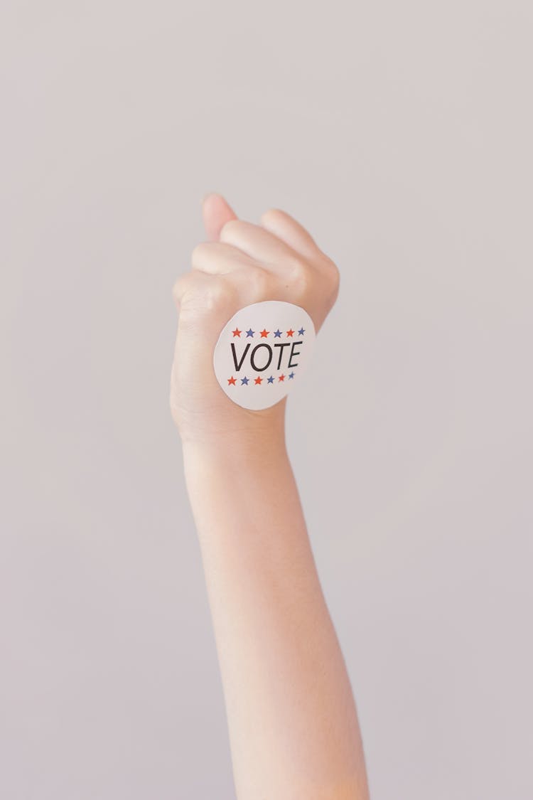 Person With Vote Sticker On Fist