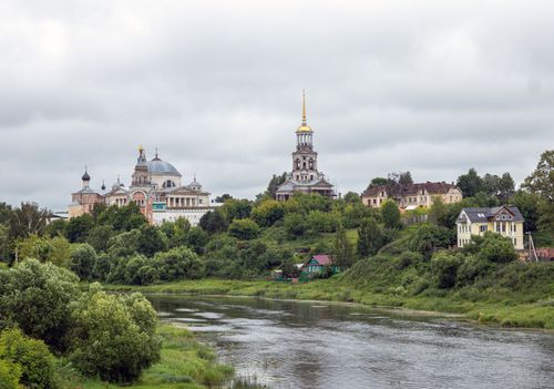 Free Scenic landscape featuring a Russian monastery, river, and surrounding greenery. Stock Photo
