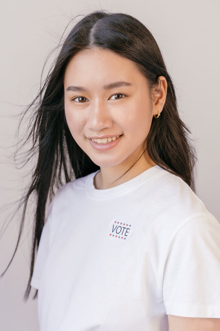 Woman With Vote Sticker On Her Shirt