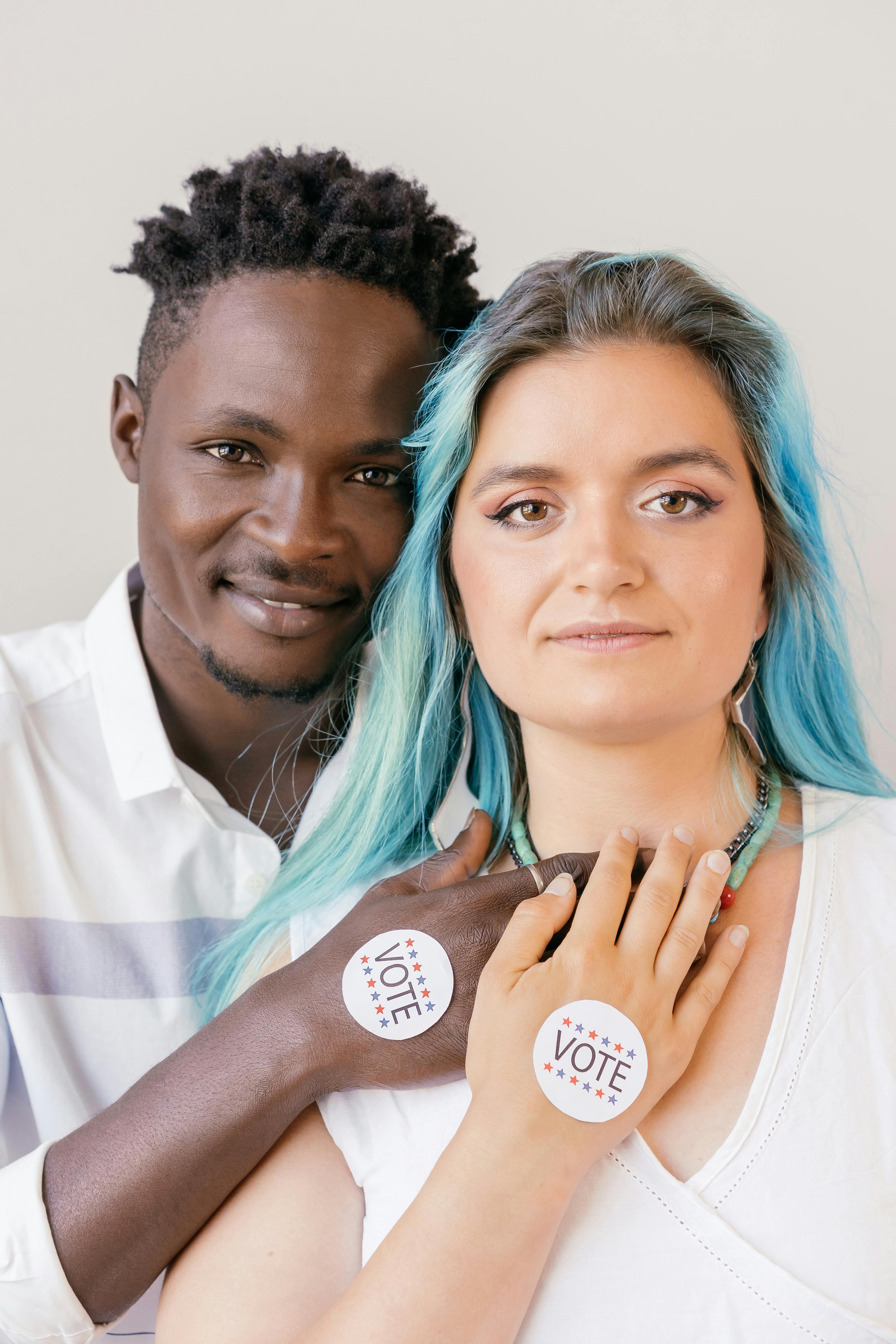 close up photo of vote stickers on people s hands