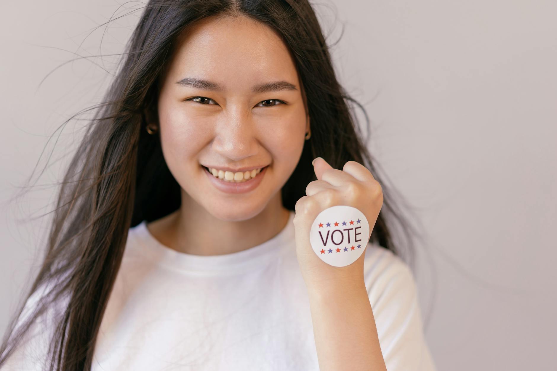 Smiling Woman with Vote Sticker on her Fist