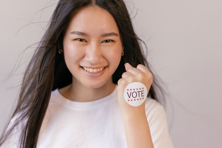 Smiling Woman With Vote Sticker On Her Fist