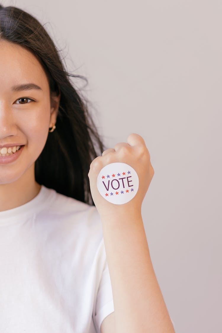 Smiling Woman With Vote Sticker On Her Fist