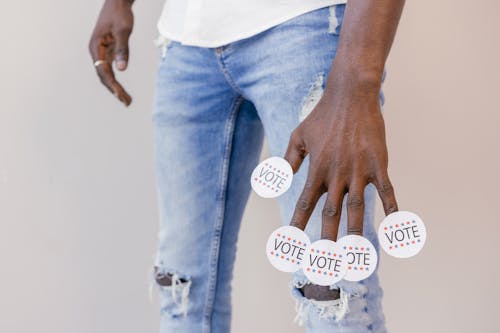 Vote Stickers on Person's Fingers