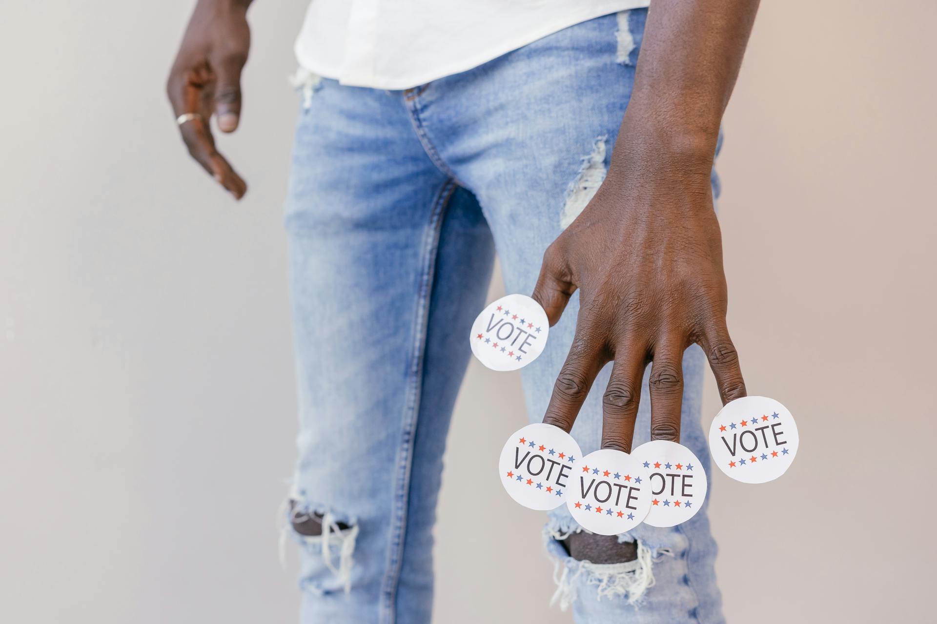 Vote Stickers on Person's Fingers