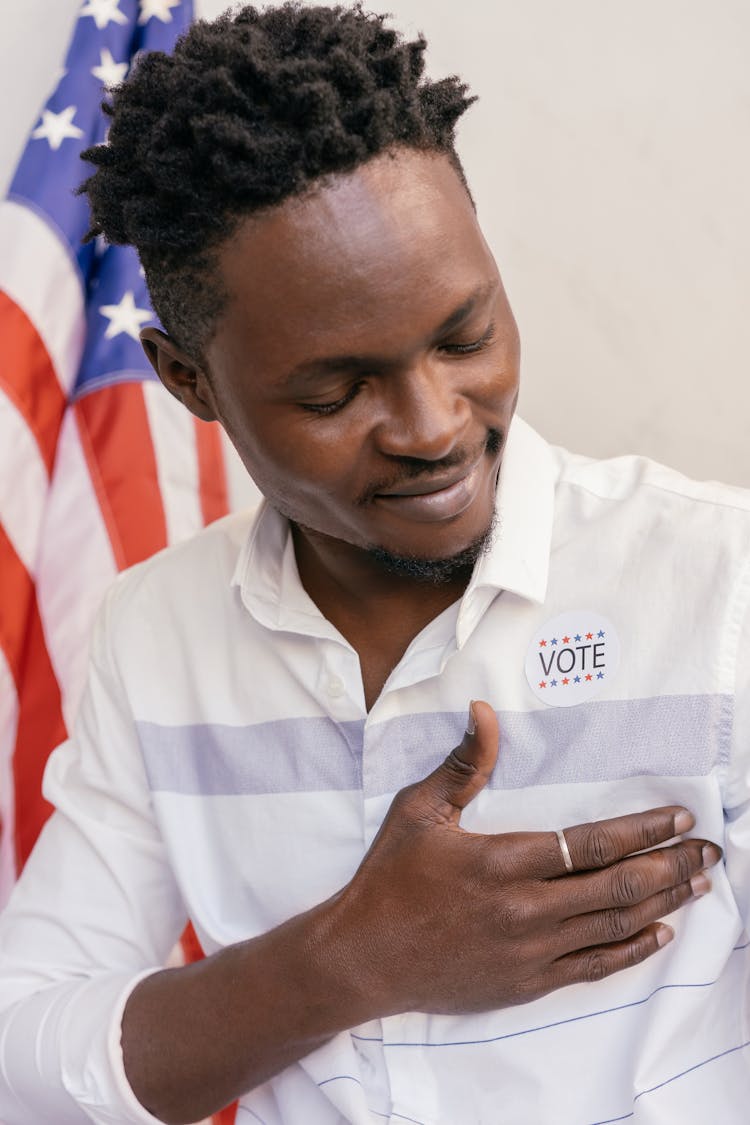 Man Looking At Vote Badge