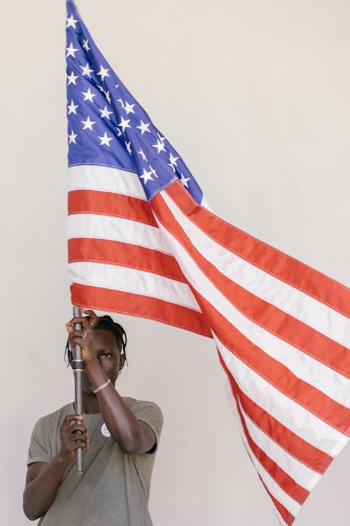 Free Man Holding a Flag Pole Stock Photo