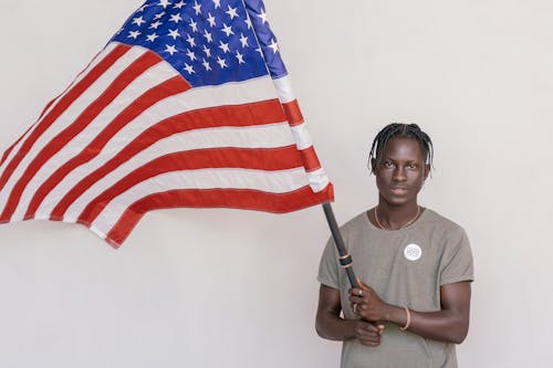 Free Man Holding a Flag Pole Stock Photo
