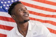 Man in White Polo Shirt with Vote Sticker on his Clothing
