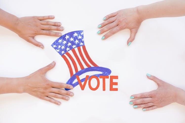 People Holding Vote Poster