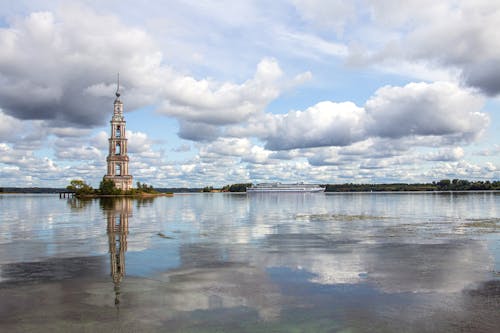 Historic Submerged Bell Tower Under Cloudy Sky