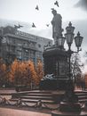 Birds Flying above a Statue