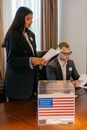 Woman in Black Blazer Holding White Paper