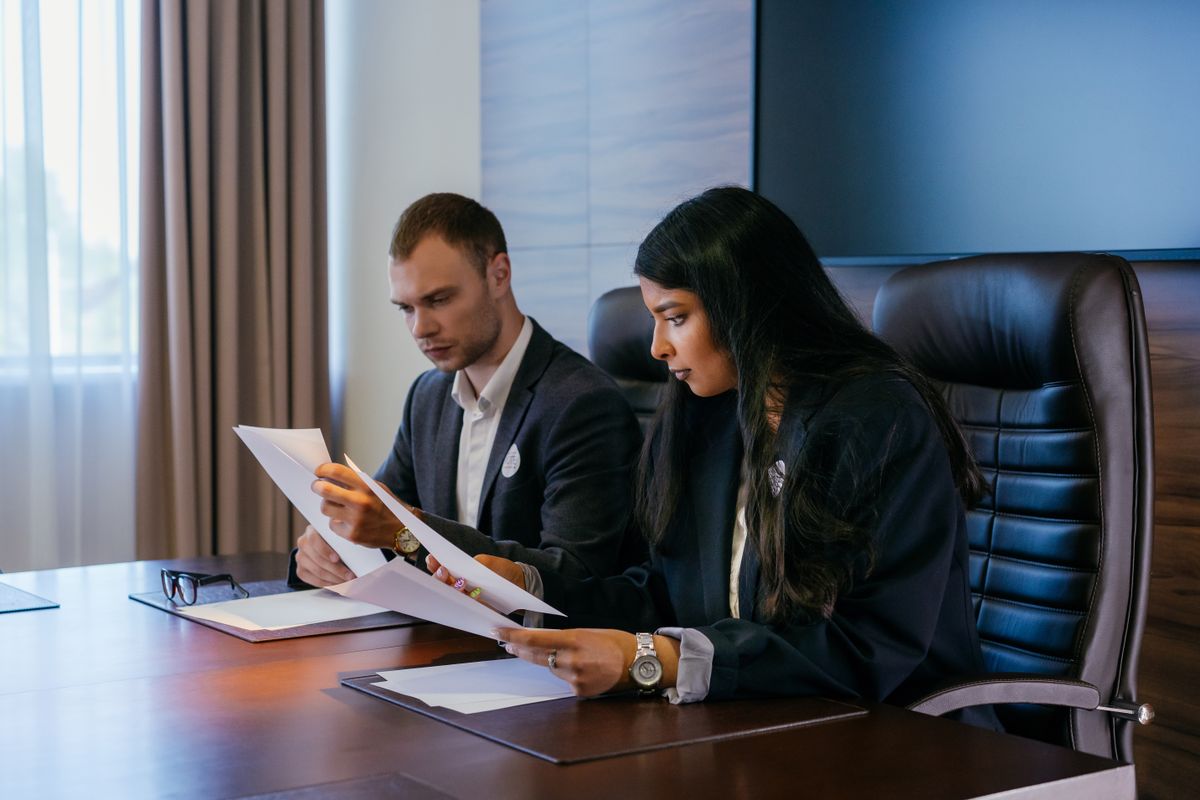 Professionals reviewing documents in an audit meeting
