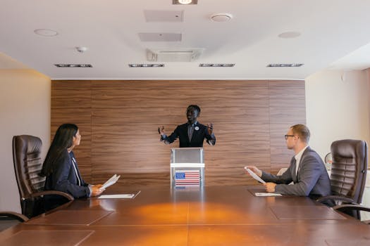 Three professionals deliberating in a modern conference room setting.