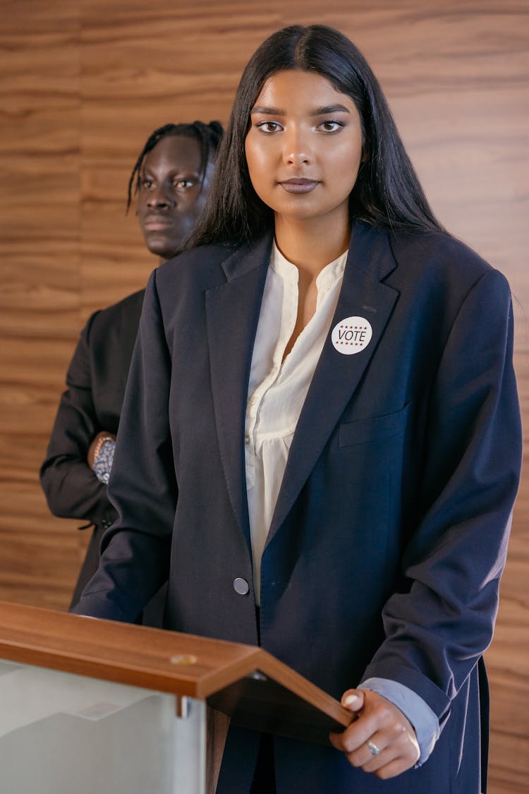 Woman Politician Behind Speech Desk 