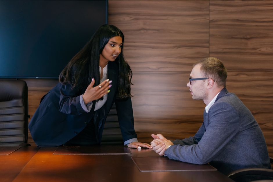Two professionals in conversation during a meeting — understanding the local language gives overseas property investors a critical negotiating edge when dealing with sellers, agents, and contractors.
