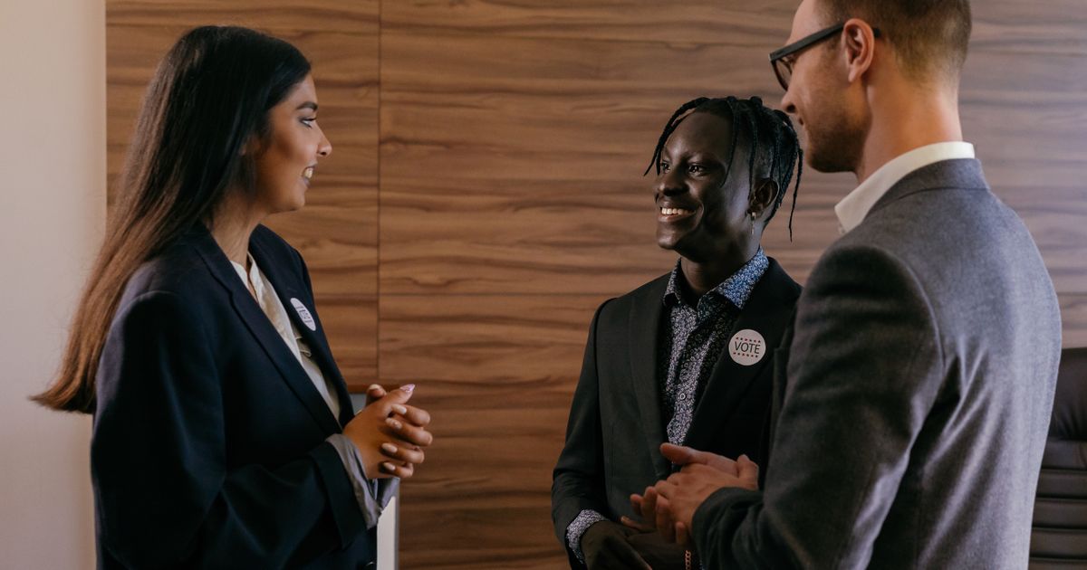 Networking: A diverse group of fitness professionals discussing at a networking event