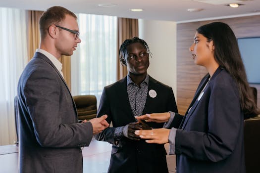 Group of professionals engaged in discussion in a modern conference room.