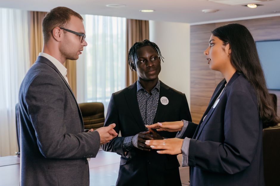 strategies for overcoming career burnout - Group of professionals engaged in discussion in a modern conference room.