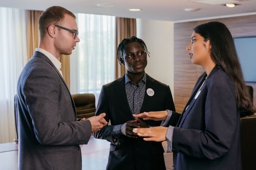 Free Group of professionals engaged in discussion in a modern conference room. Stock Photo
