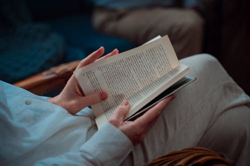 Free Person Sitting With An Open Book Stock Photo