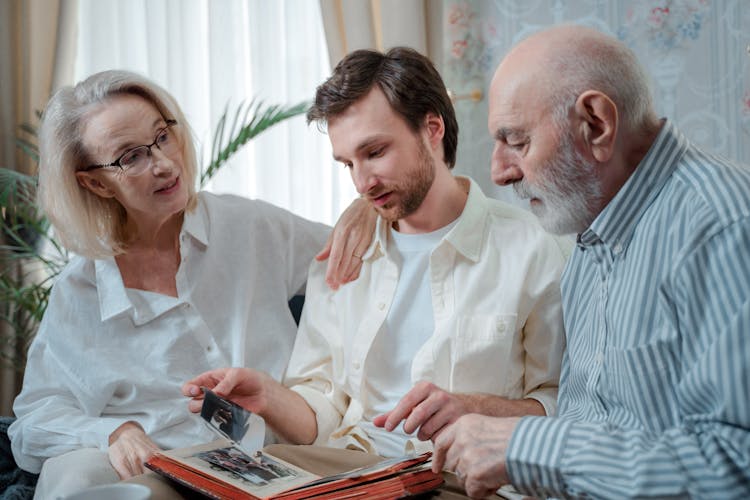 A Family Looking At Pictures 