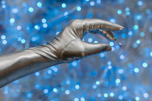 Close-up of a metallic glove against a vibrant blue bokeh background, evoking a futuristic theme.