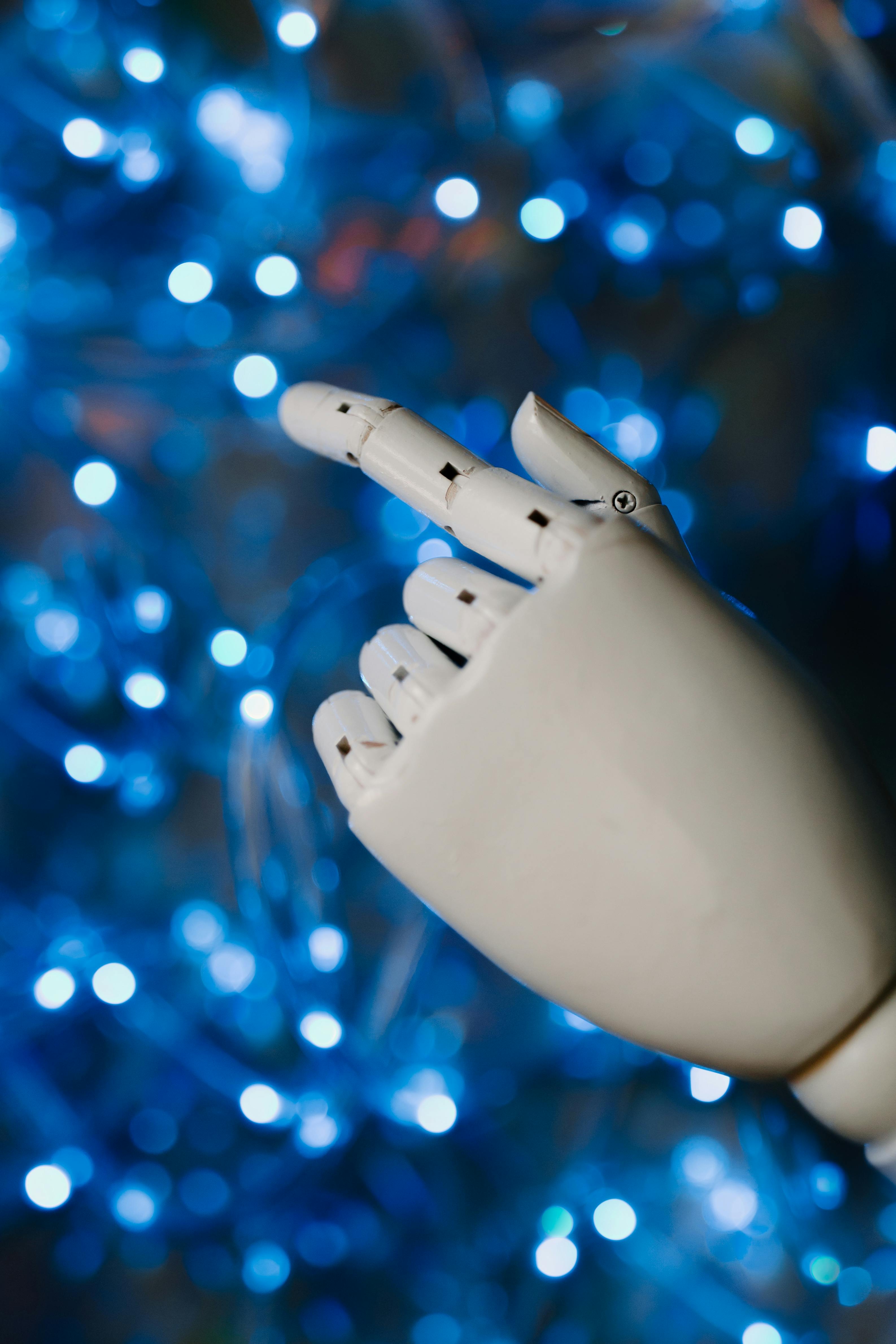 white robot hand in close up photography