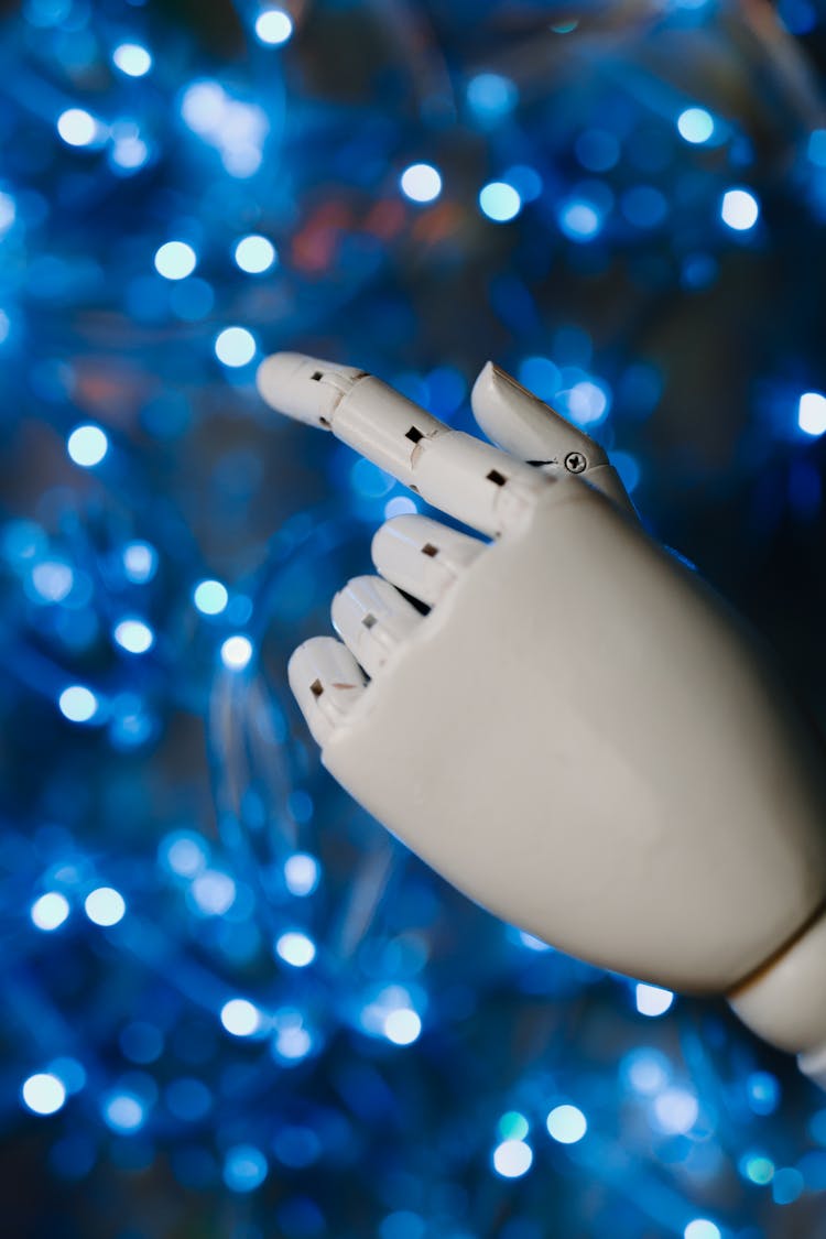 White Robot Hand In Close Up Photography